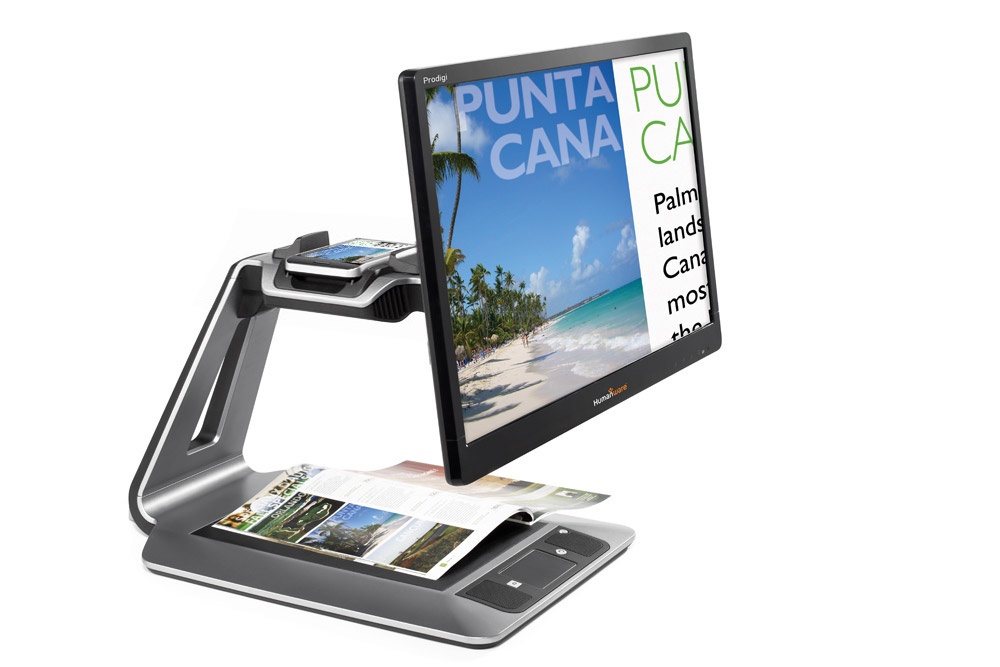 A desktop magnifier enlarging the text and image of a magazine.