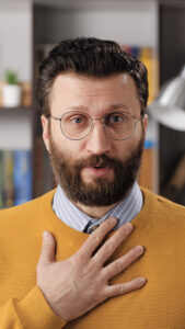 Image shows man looking apologetic and saying “sorry.”