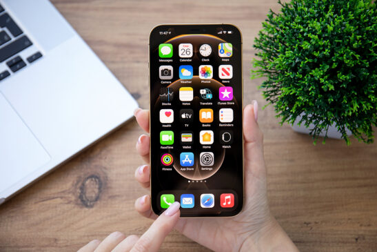 Image shows woman at work using iPhone with voiceOver.
