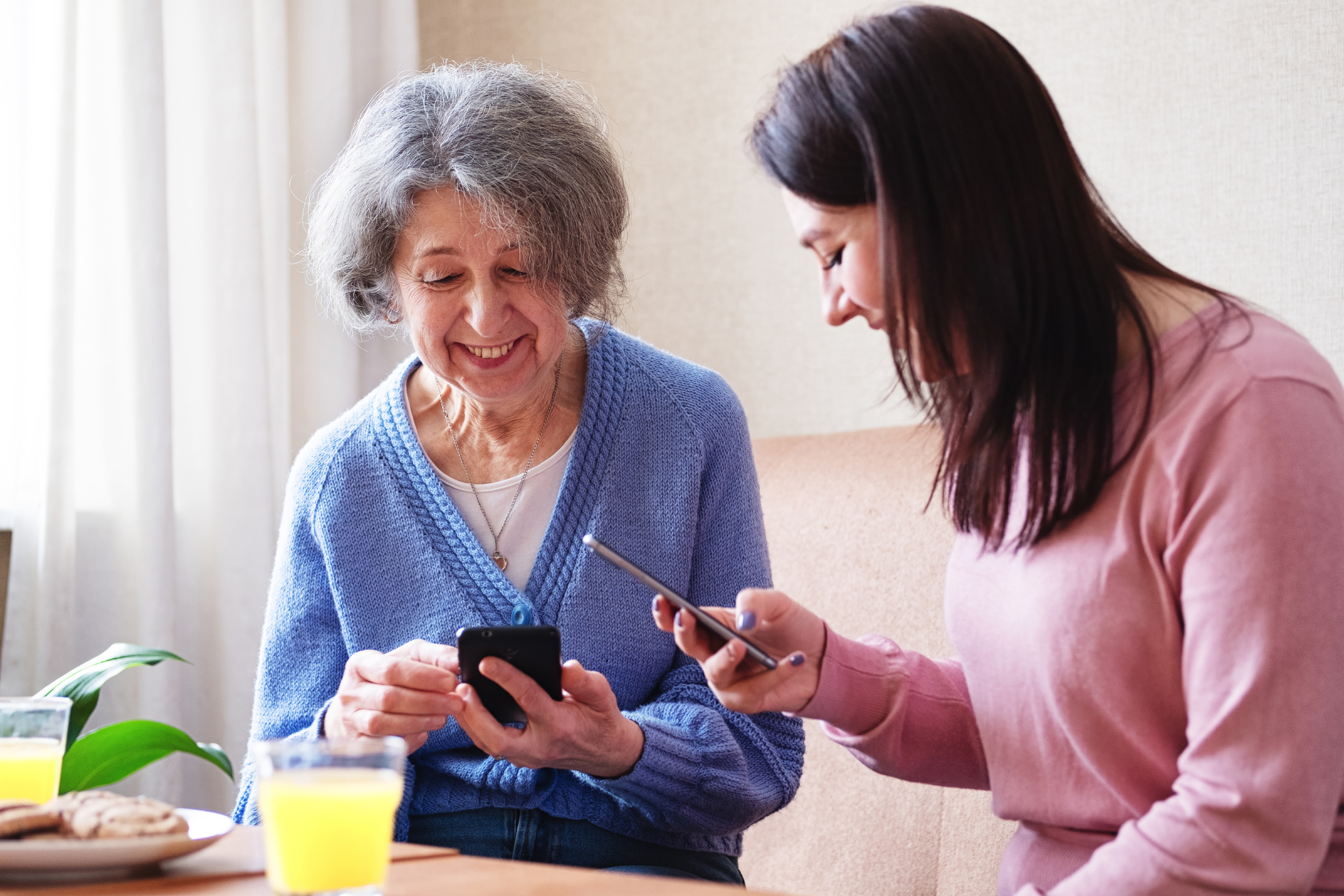 Woman with teacher in smartphone training session