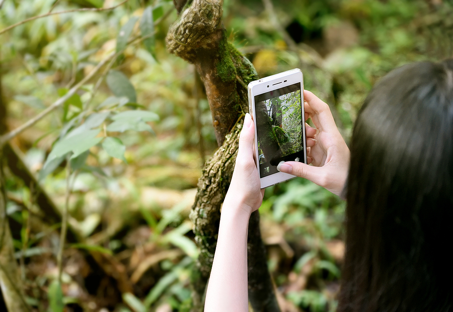 Image shows woman with Aira app camera showing the scene around her.