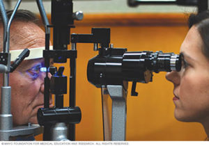 Woman giving man eye pressure test