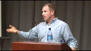 Image of Frank Bruni speaking at a podium.