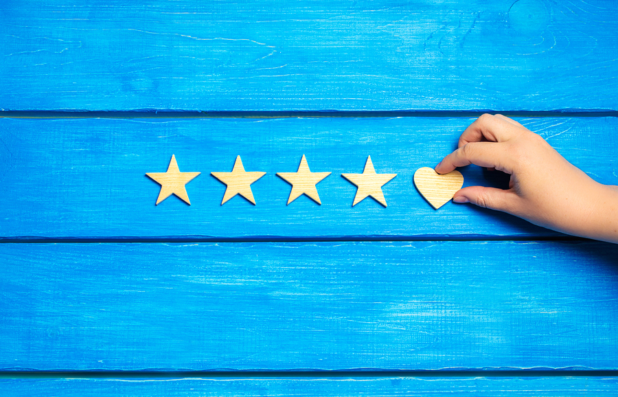 Four Stars And Heart On A Blue Background.