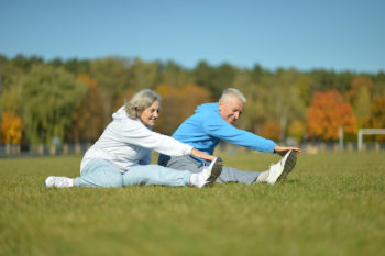 Image shows youthful seniors exercising outdoors.