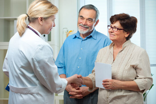 Couple meet with physician to discuss participation in clinical trial.