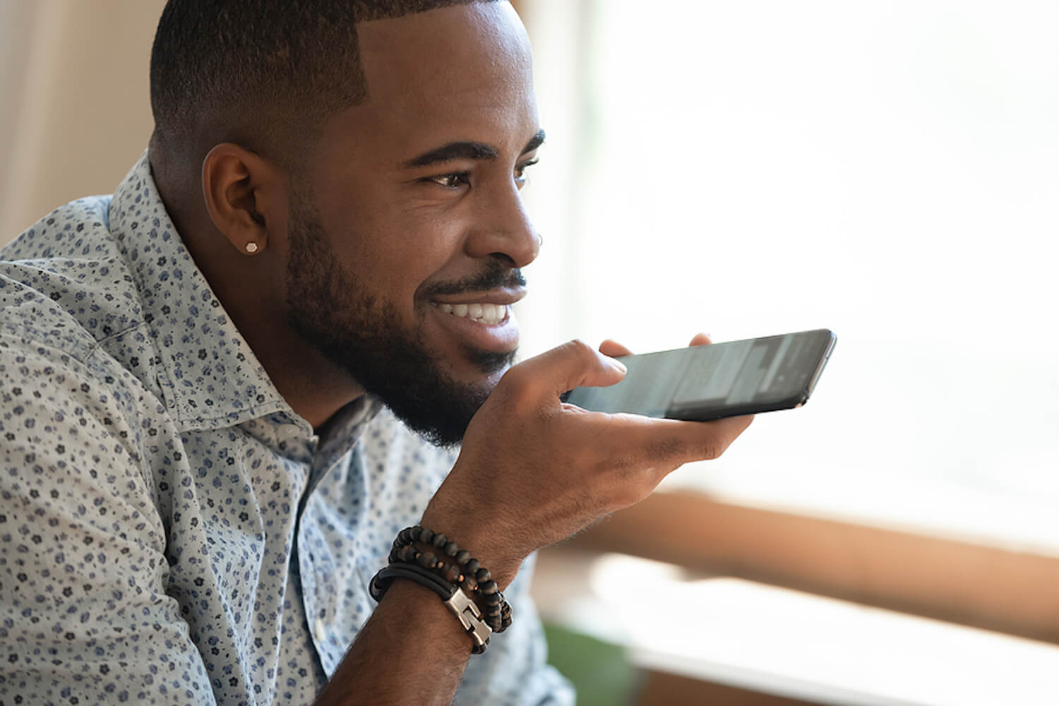 Man scheduling calendar appointment using voice assistant.