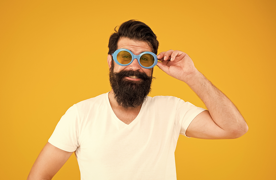 Image shows man wearing large protective sunglasses