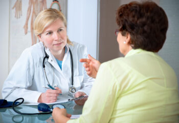 Image shows patient talking with primary care provider.