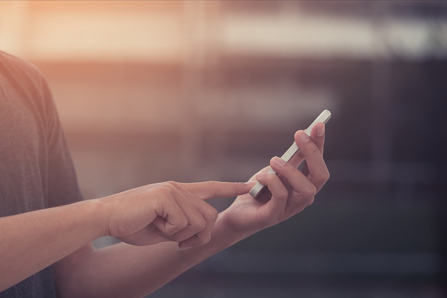 Image shows hands tapping VoiceOver gestures on iPhone.