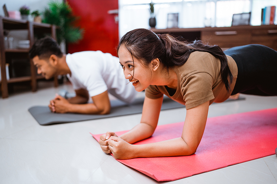 Couple exercising together at home