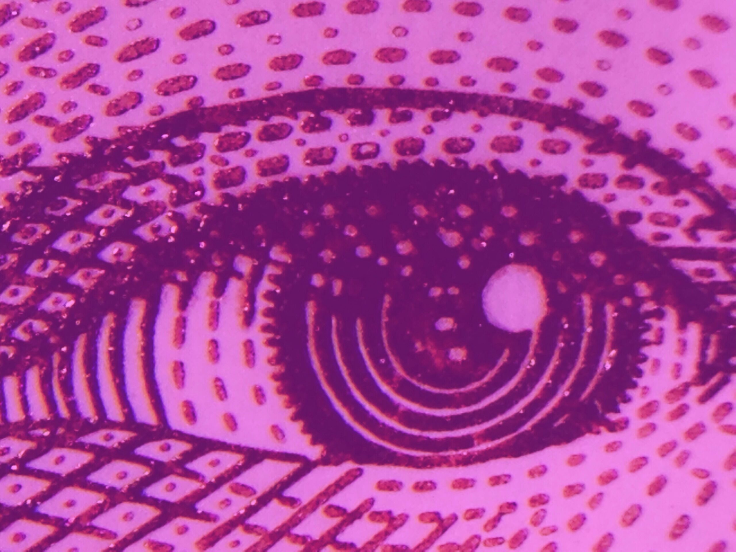 Artistic close up image of eye on pink background