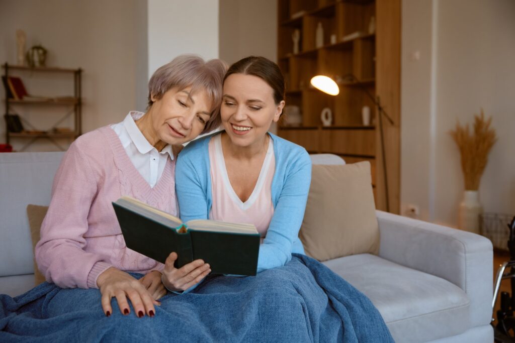 Adult daughter reading to her Mom