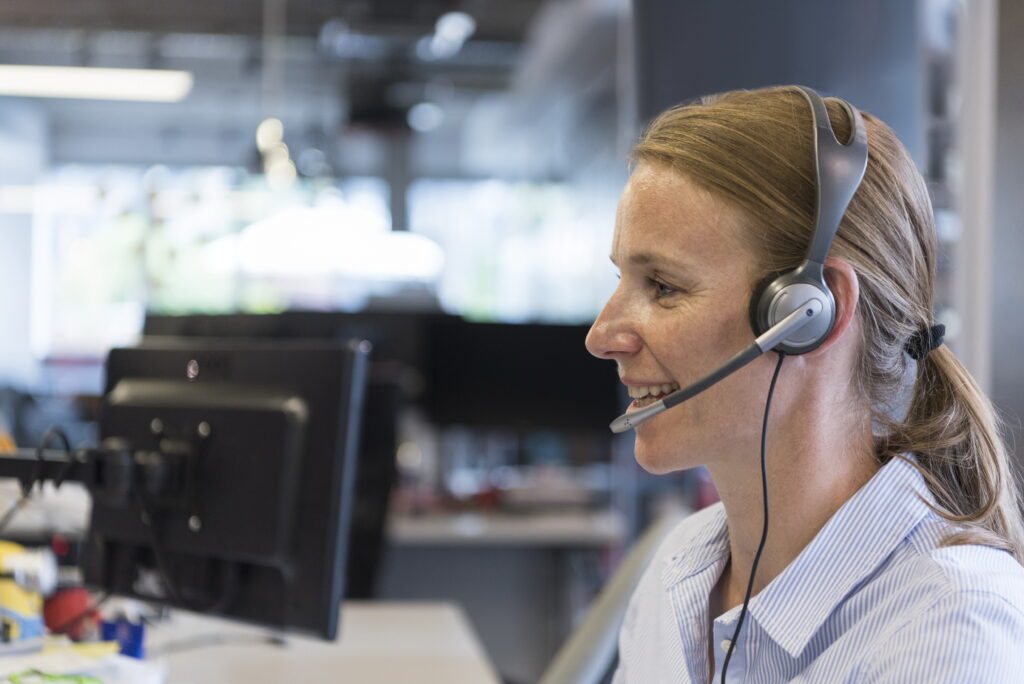 Accessibility support specialist helps customer with vision settings.