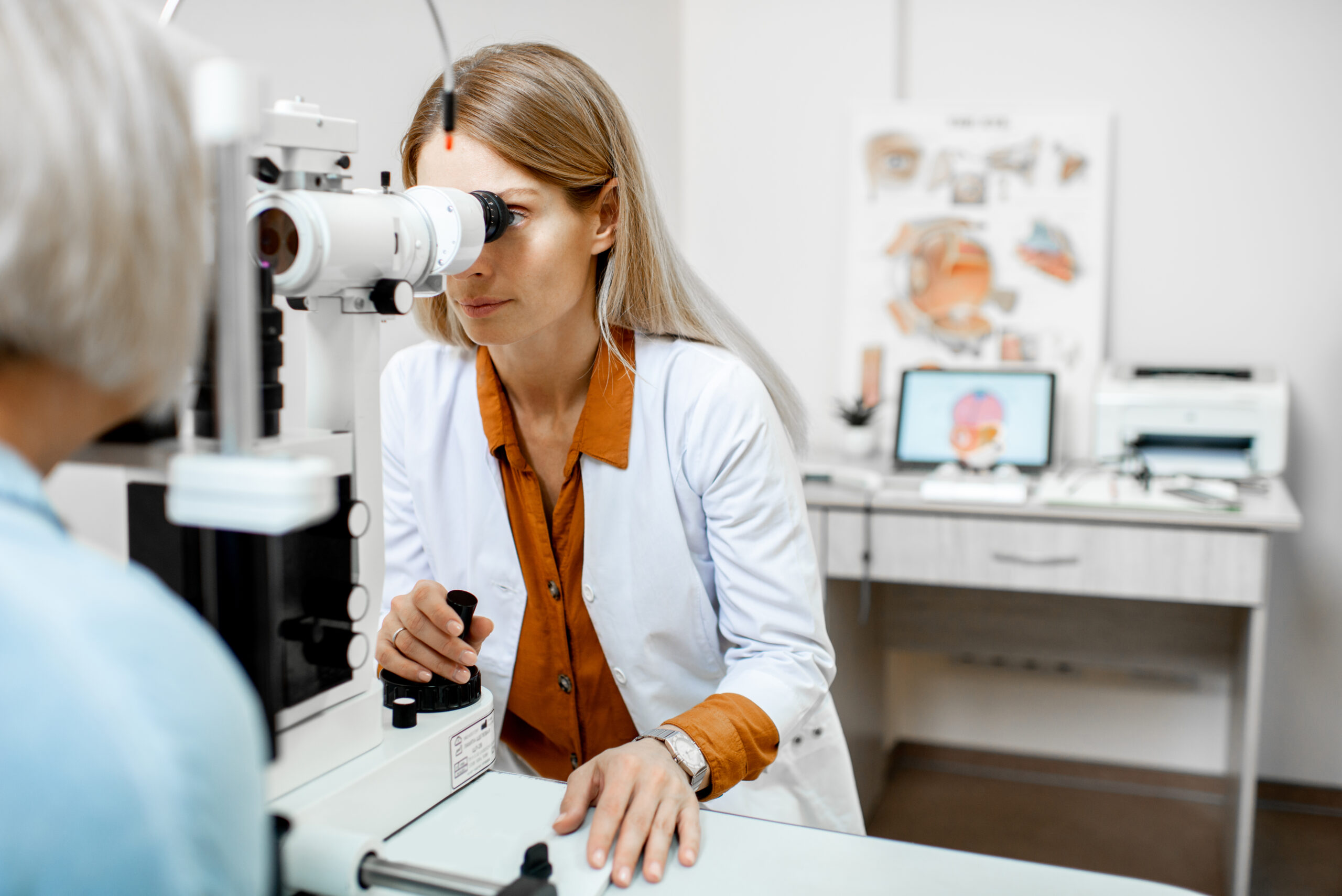 Ophthalmologist examining patient in office