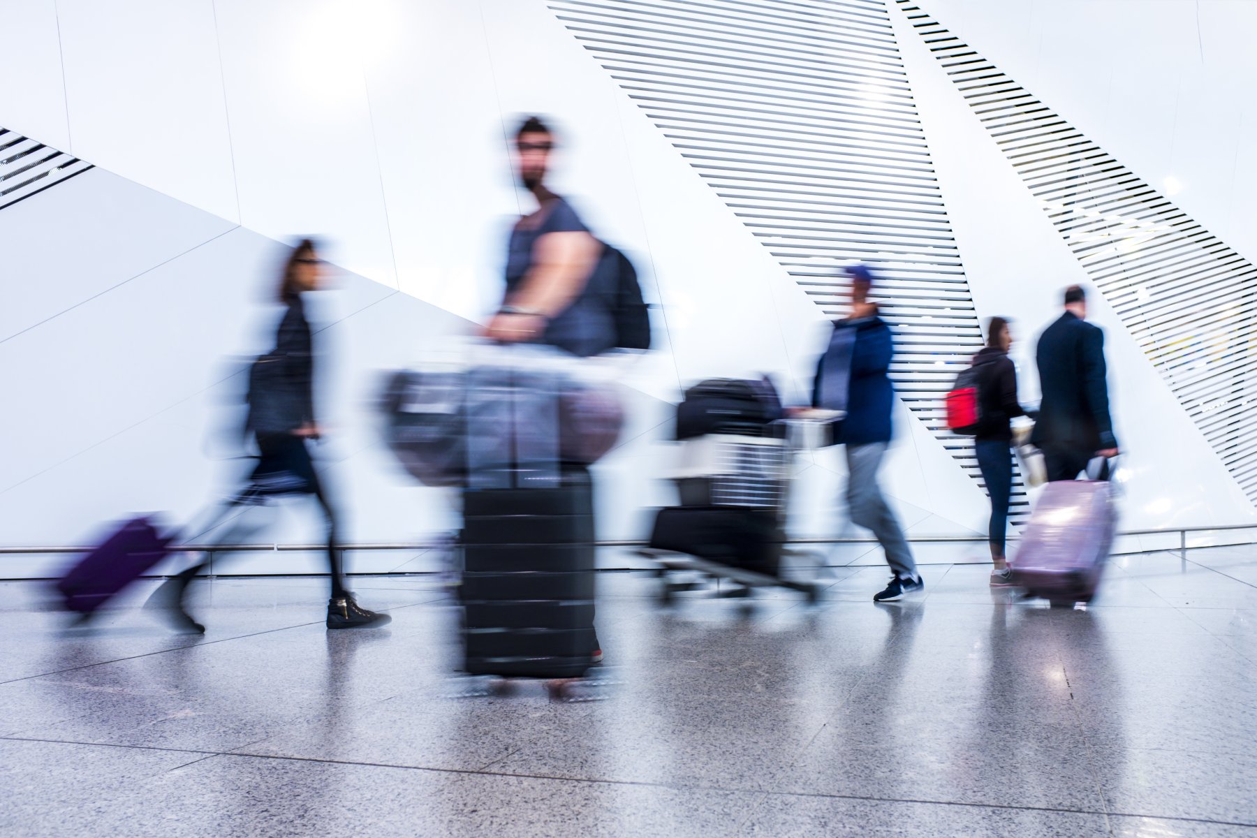 Blurred image of passengers moving through airport